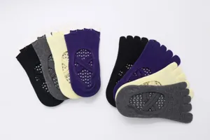 Detailed view of five toe yoga socks with double straps and non slip grip dots for pilates.