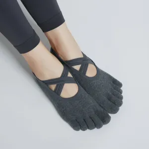 Premium dark gray five-toe yoga socks with cross straps, perfect for anti-slip pilates workouts.