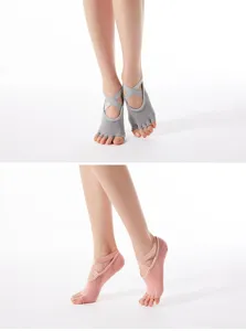 Non-slip yoga socks for women, breathable cotton five-toe design with cross straps for grip.