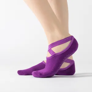 Purple yoga socks with cross straps, non-slip grip soles, ideal for dance and fitness training.