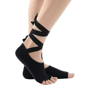 Black cotton yoga socks with grip sole, open toe and stylish ankle straps for dance practice.