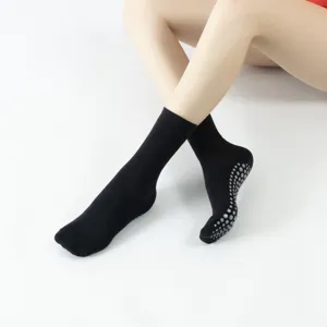 Black non-slip yoga socks with grip dots for women and men, breathable fitness pilates.