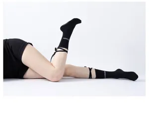 Black strap yoga socks for women, non-slip pilates dance socks with cross tie detail.