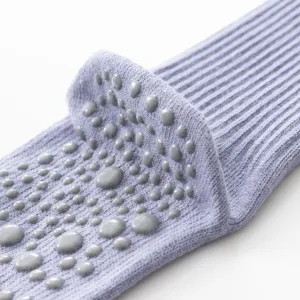Close-up detail of lavender yoga pilates grip socks with anti-slip silicone dots for fitness.