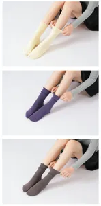 Detail view of women lettuce trim yoga socks featuring non-slip grip and soft mid-calf fit.