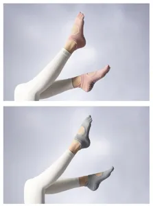 Detailed view of women's five-toe grip pilates socks with cutout back and non-slip sole.