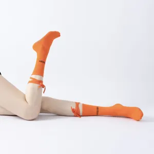 Trendy orange strap yoga socks for women, perfect for pilates, fitness and dance workouts.