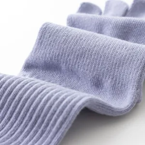 Close-up detail of soft ribbed yoga toe socks in light purple, showing fine knit texture.