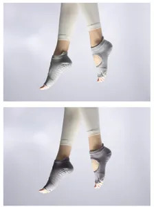 Detail view of grey non-slip yoga socks with open toe and arch design for women fitness.
