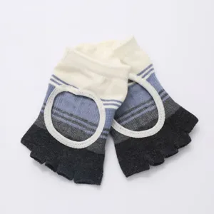 Close-up detail of color-blocked open-back five-toe yoga socks with circular cutouts and grip.