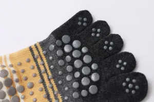 Detailed close-up of women five-toe yoga socks featuring anti-slip grip dots and striped knit.