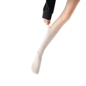 Beige long tube socks for women, cozy knitted casual hosiery, perfect for yoga and daily wear.