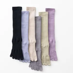 Close-up view of multi-color five-toe compression yoga socks, featuring ribbed design details.