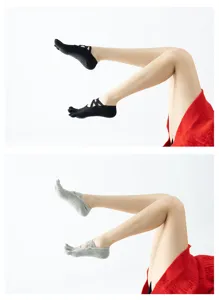 Women's non-slip yoga socks with cross straps and toe separation for pilates fitness.