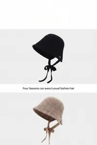 Classic knit bucket hat with chin ties for women, casual autumn and winter fashion accessory.