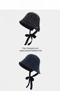 Detail view of knitted bucket hat with ribbon tie, wool blend material, versatile casual daily wear.