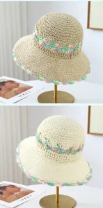 Detailed view of pastoral style women's woven straw hat with colorful floral crochet brim.