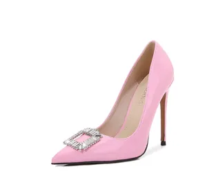 Pink patent leather high heels detail featuring a sparkling crystal square buckle and stiletto heel.