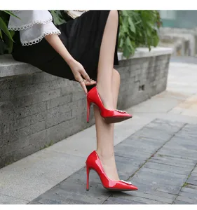 Elegant red patent leather stiletto high heels featuring a sparkling rhinestone square buckle.