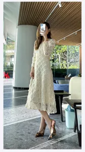 Detailed shot of women white lace dress and leopard print stiletto heels in modern interior.