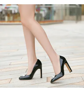 Elegant black patent leather high heels with crystal buckle for women stylish dress shoes.