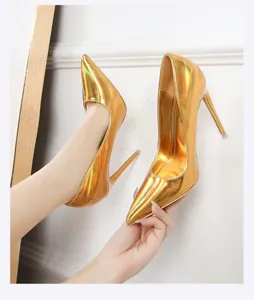 Detailed shot of shiny gold metallic stiletto high heels with sharp pointed toe and sexy slim heel.