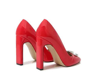 Red patent leather chunky high heels featuring a dazzling crystal buckle and square toe.