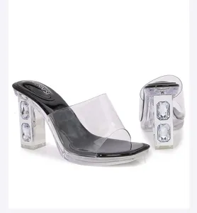 Detailed view of clear rhinestone block heel sandals with transparent straps and chic platform.