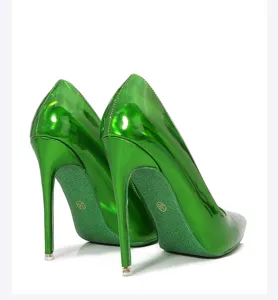 Glossy green stiletto high heels detail, vibrant patent leather and sharp pointed toe design.