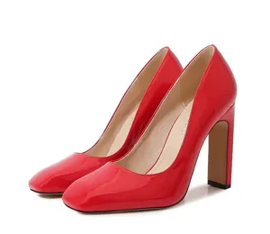 Red patent leather chunky high heels detail shot showing elegant square toe and gloss.