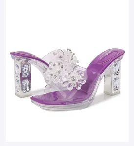 Detail view of purple crystal chunky heel transparent high heel mules with floral rhinestone straps.