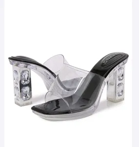 Clear chunky high heel sandals with sparkling rhinestones and transparent PVC upper.