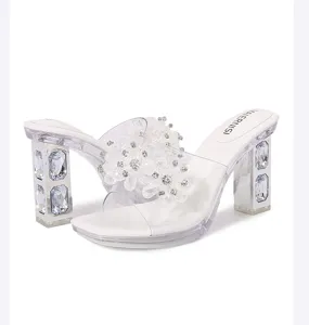 Detail view of crystal rhinestone embellished clear block heel high heeled sandals, elegant mules.