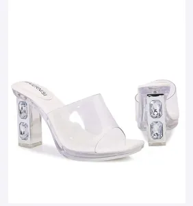Crystal block heel detail of clear strap high heeled sandals with white platform sole.