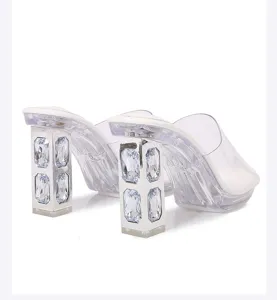 Clear rhinestone chunky heel high heel sandals detail view showing sparkling gemstone.
