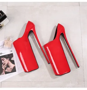 Detail shot of red patent leather extreme high heels with massive platform for pole dancing.