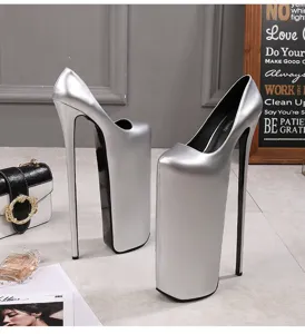 Detail view of silver metallic extreme platform stiletto high heels, stylish pole dancing shoes.