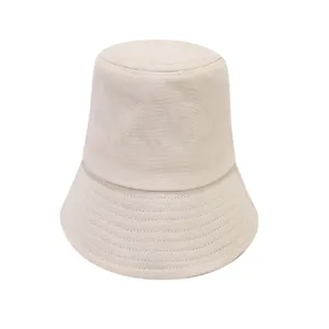 Detailed view of the casual beige cotton bucket hat, featuring neat stitching on the brim.