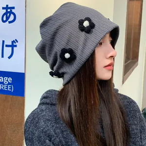 Dark gray waffle knit slouchy beanie for women with cute crochet flower design, stylish and cozy.