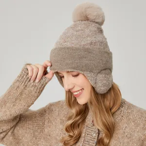 Detalle de primer plano del acogedor gorro de invierno con orejeras y pompón suave.