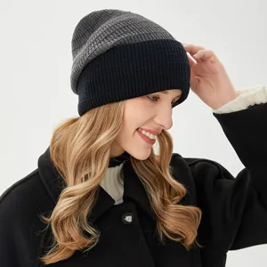 Detail shot of the two-tone ribbed knit beanie worn by model, showing texture and fit.