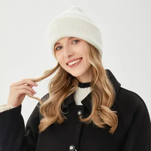 White ribbed knit beanie hat for women, soft warm winter headwear accessory for cold weather.
