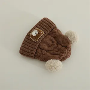 Cute baby winter knitted beanie hat with fluffy pom-poms and cute bear patch for toddlers warm