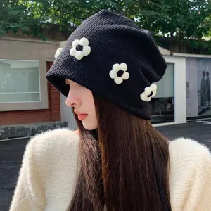 Black knit slouchy beanie for women featuring 3D white flower accents Korean style streetwear hat