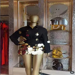 Detailed view of the luxurious long-sleeve sequin blouse and skirt set in a chic boutique display.