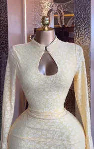 Details of the yellow lace long sleeve hollow dress, featuring exquisite floral patterns.