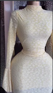 Detailed view of the yellow floral lace long sleeve mini dress showcasing the delicate fabric.