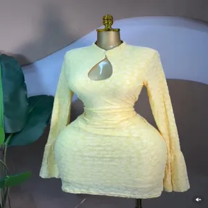 Detail shot of a stylish yellow long sleeve hollow out jacquard mini dress for women.