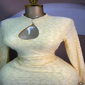 Detailed view of the yellow long-sleeve jacquard dress featuring a chic chest cutout and stand collar.