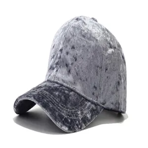 Close-up detail of the soft grey crushed velvet fabric texture on the stylish baseball cap.